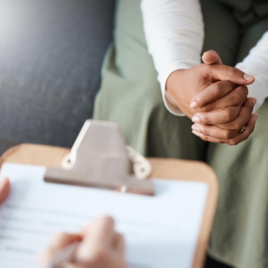 A mental health professional with a clipboard documents a client's potential need for a psychological service dog.